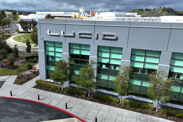 In an aerial view, a sign is posted on the exterior of Lucid headquarters on March 29, 2023 in Newark, California. 